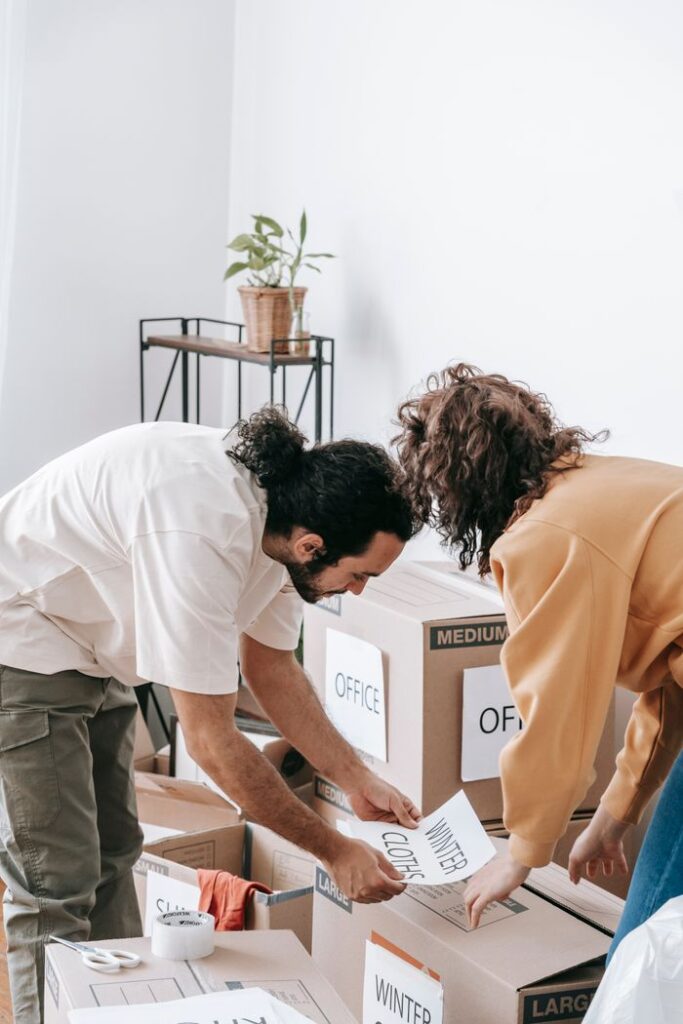 The Art of Drawing Readers In: Your attractive post title goes here Couple organizes and labels boxes while preparing to move out of their apartment.