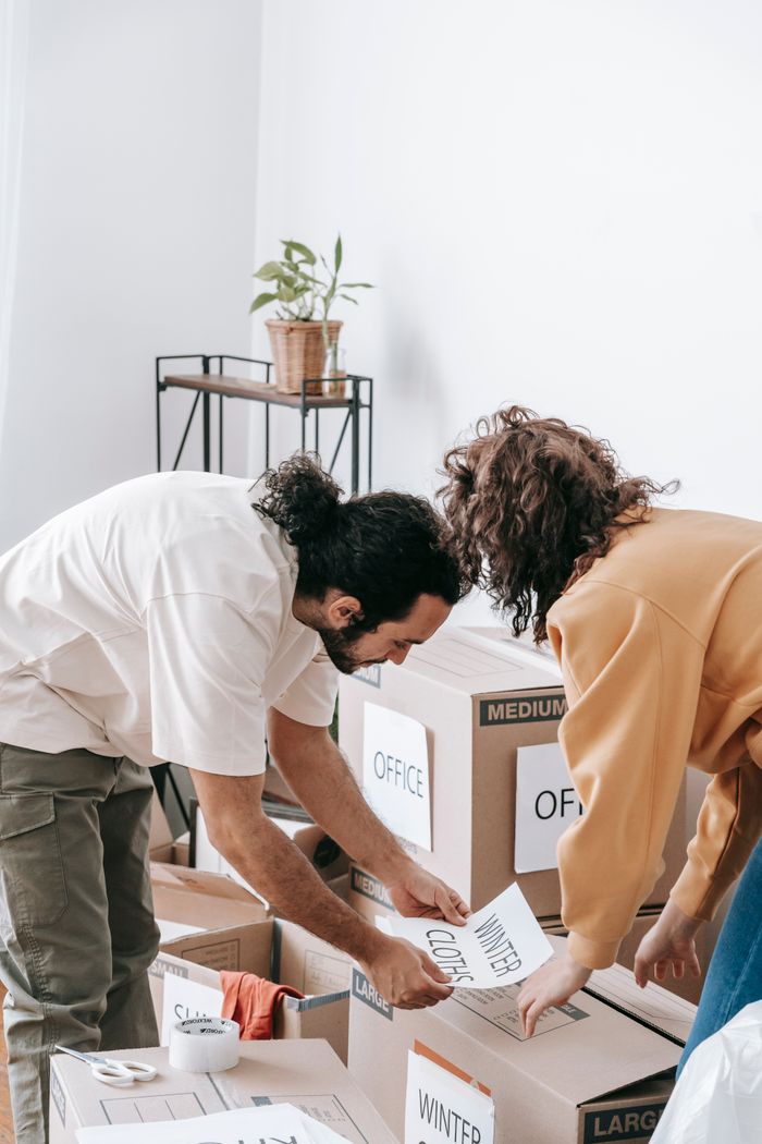 The Art of Drawing Readers In: Your attractive post title goes here Couple organizes and labels boxes while preparing to move out of their apartment.